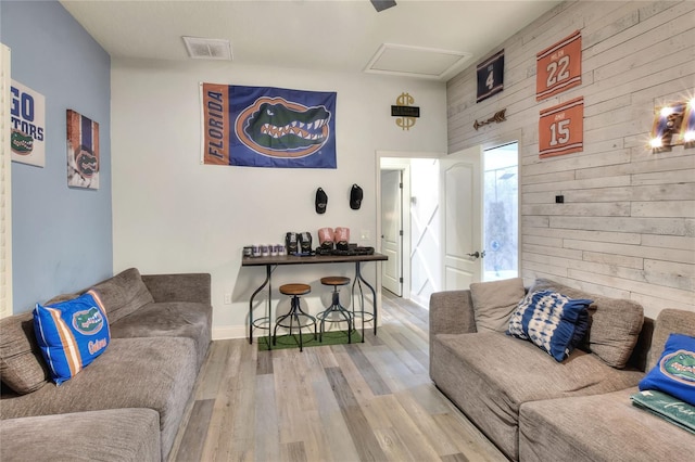 living room featuring wooden walls and hardwood / wood-style floors