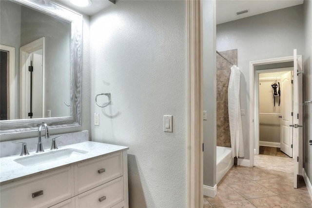 bathroom with tile patterned floors, vanity, and shower / tub combo