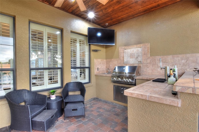 view of patio featuring a grill, area for grilling, and sink