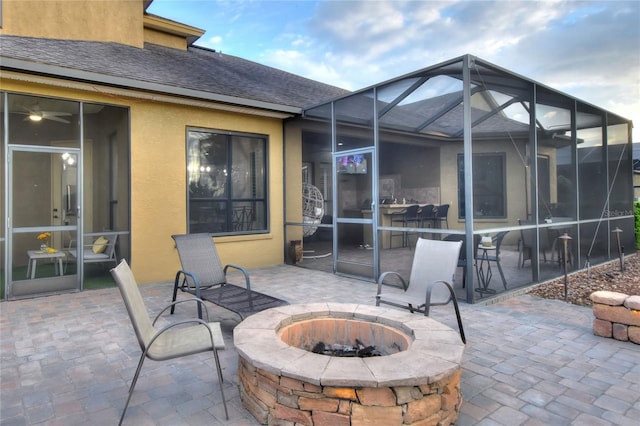 view of patio / terrace featuring a lanai and an outdoor fire pit