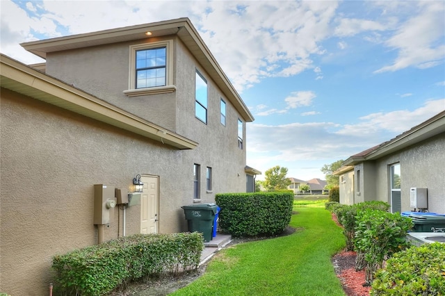 view of side of home featuring a lawn