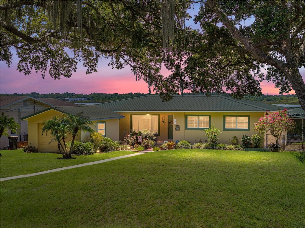 ranch-style home featuring a yard