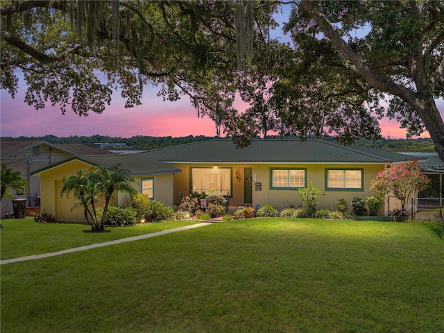 ranch-style home featuring a yard