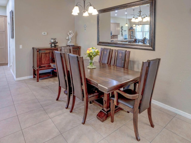 tiled dining room featuring a notable chandelier