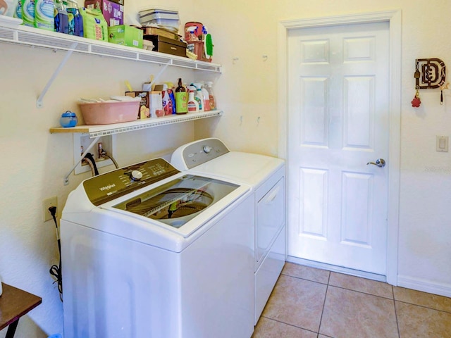 laundry room with washer and dryer and light tile patterned flooring