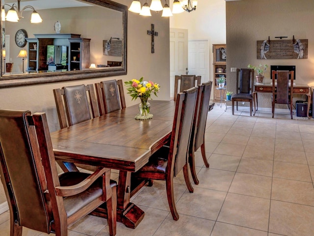 dining area with light tile patterned flooring and an inviting chandelier