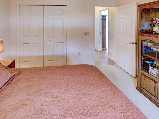 bedroom with light carpet and a closet