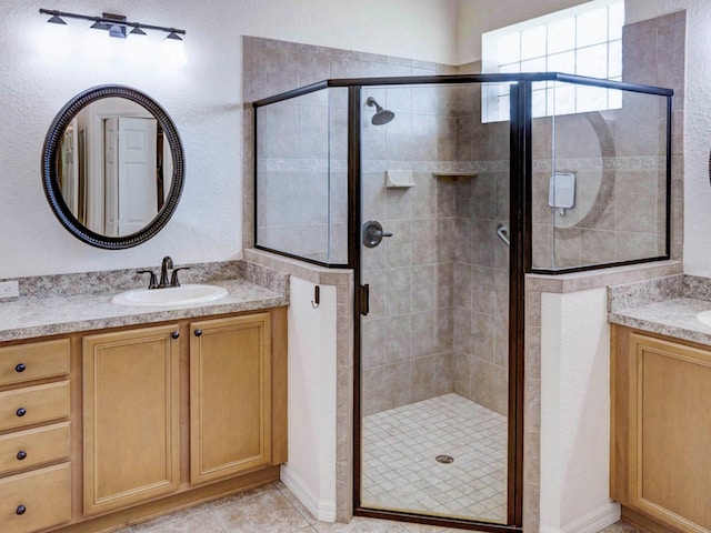 bathroom featuring vanity and a shower with shower door