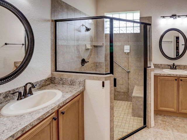 bathroom featuring vanity, tile patterned floors, and an enclosed shower