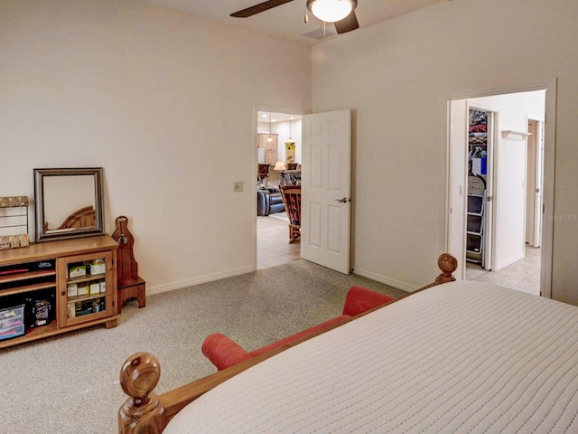 bedroom featuring light carpet, a closet, and ceiling fan