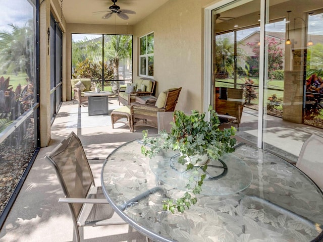 sunroom / solarium featuring ceiling fan