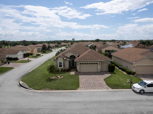 ranch-style house featuring a front lawn and a garage