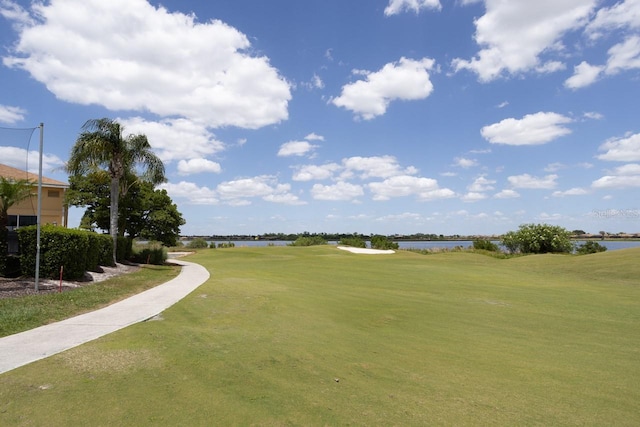 view of property's community featuring a water view and a lawn