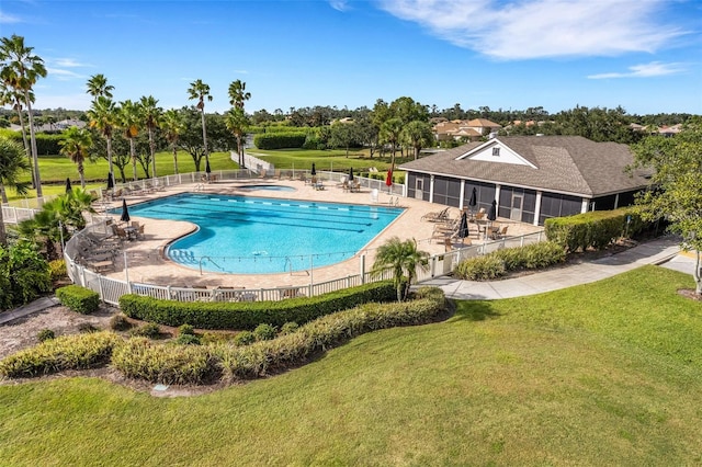 view of swimming pool featuring a lawn and a patio