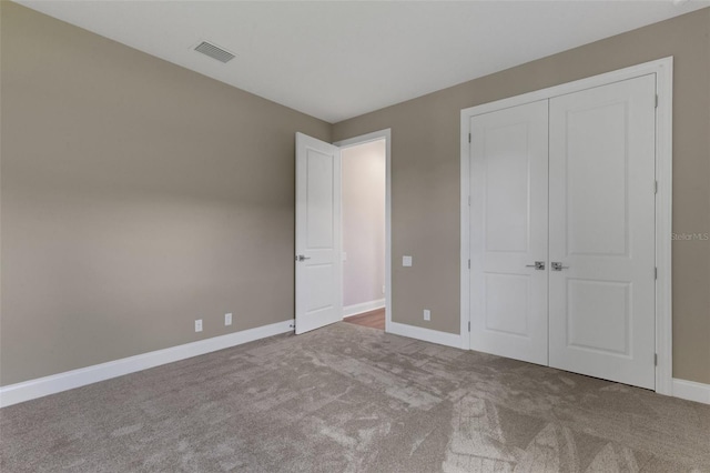 unfurnished bedroom featuring a closet and carpet flooring