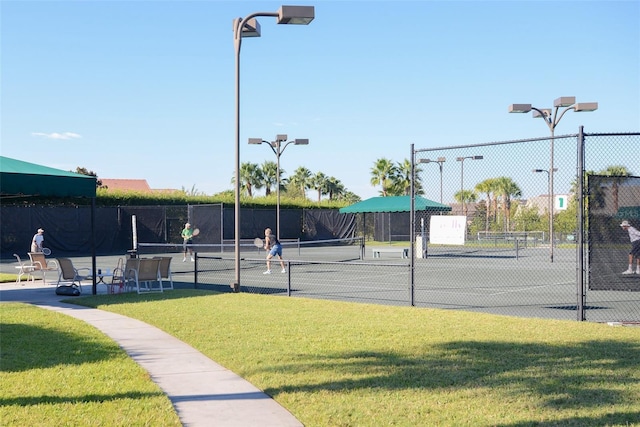 view of sport court with a lawn