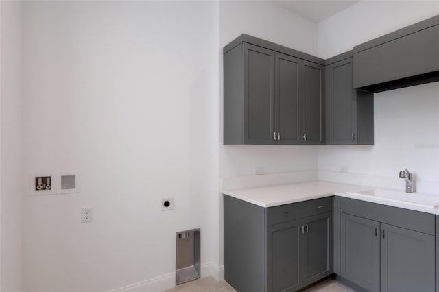 clothes washing area featuring sink, light tile patterned flooring, hookup for a washing machine, hookup for an electric dryer, and cabinets