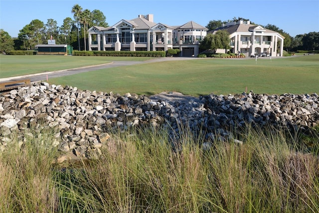 view of home's community with a yard