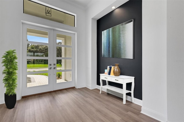 entryway featuring plenty of natural light, light hardwood / wood-style flooring, french doors, and ornamental molding