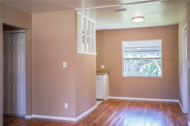 unfurnished room with dark hardwood / wood-style floors