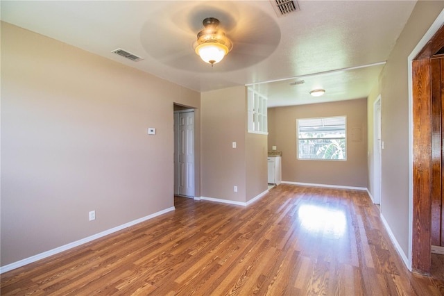 unfurnished room with ceiling fan and hardwood / wood-style flooring