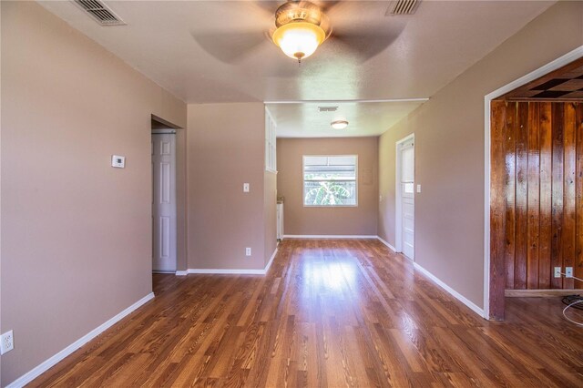 empty room featuring ceiling fan and dark wood-type flooring