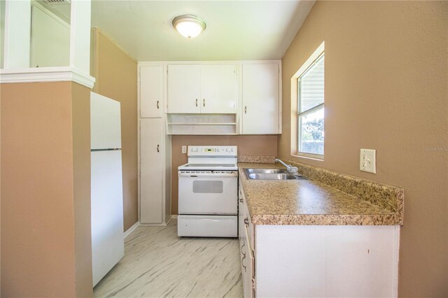 kitchen featuring sink, white cabinetry, and white appliances