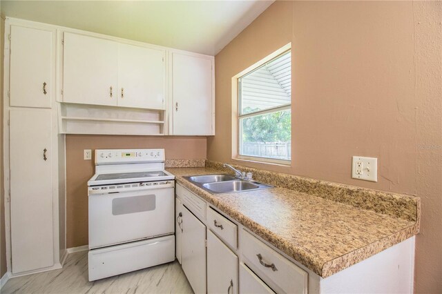 kitchen with light tile patterned flooring, sink, electric stove, and white cabinets