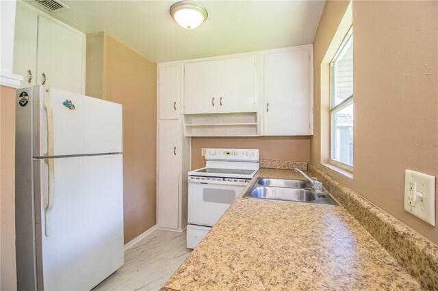 kitchen featuring sink, white appliances, white cabinetry, and light tile patterned floors