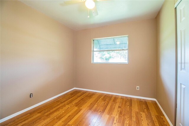 unfurnished room with ceiling fan and hardwood / wood-style flooring