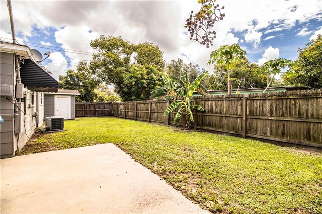 view of yard with central AC unit and a patio