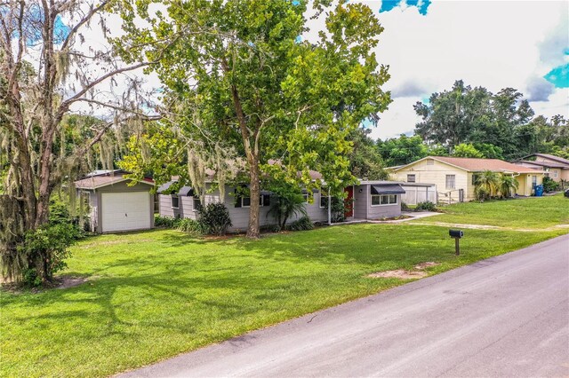 ranch-style house featuring a front lawn and a garage