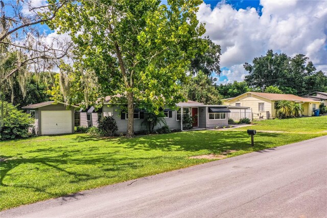 single story home featuring a front yard and a garage