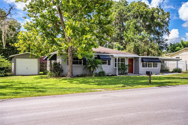 ranch-style house with a garage and a front yard