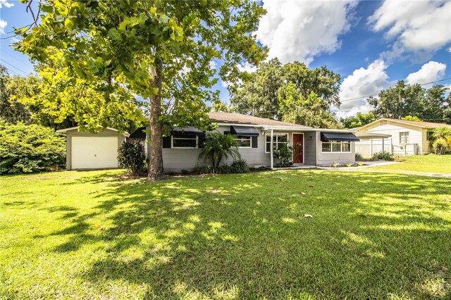 ranch-style home featuring a front yard and a garage