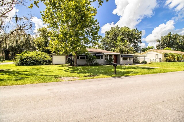 ranch-style house with a garage and a front yard