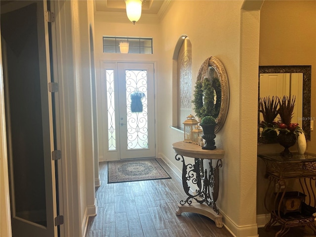 foyer with a healthy amount of sunlight and crown molding