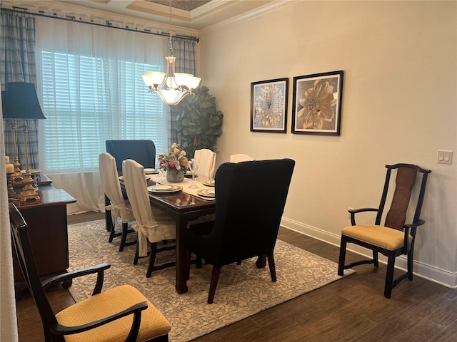 dining room with crown molding, hardwood / wood-style floors, and a notable chandelier