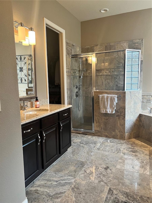 bathroom featuring shower with separate bathtub and vanity