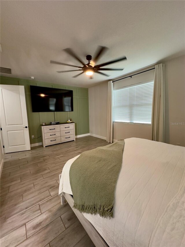 bedroom with ceiling fan and light hardwood / wood-style flooring