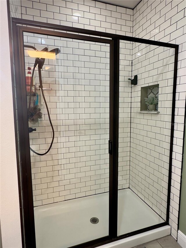 bathroom with a shower with shower door