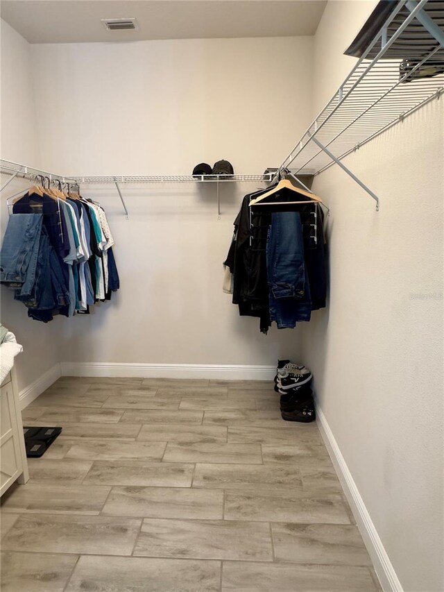 spacious closet featuring light hardwood / wood-style flooring