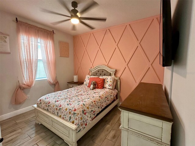 bedroom with ceiling fan and hardwood / wood-style floors