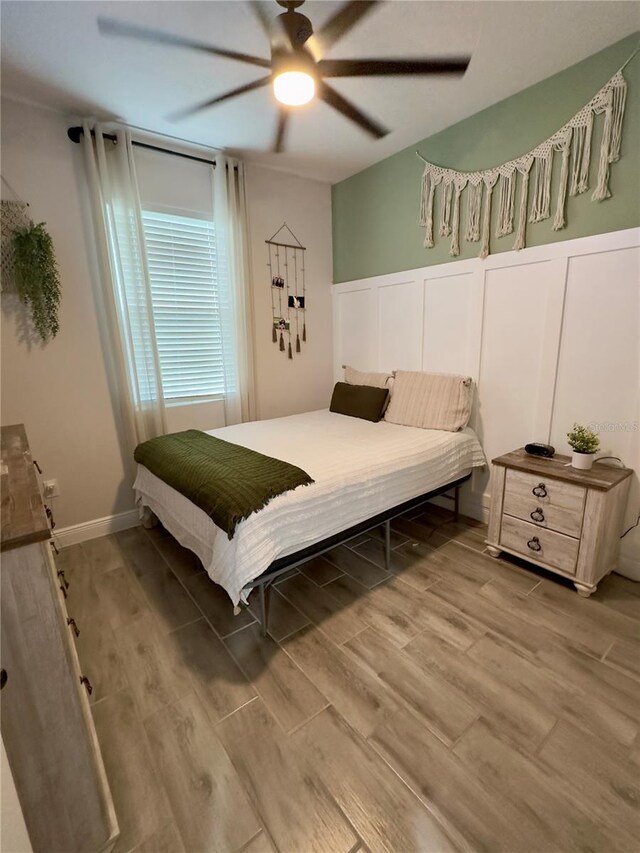 bedroom featuring ceiling fan and wood-type flooring