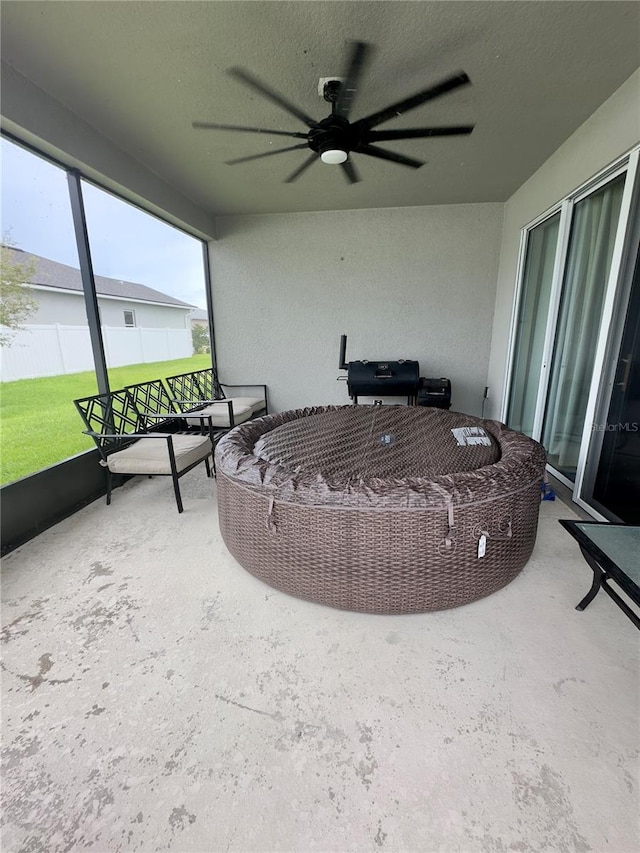 sunroom featuring ceiling fan