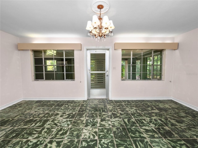 empty room with a notable chandelier