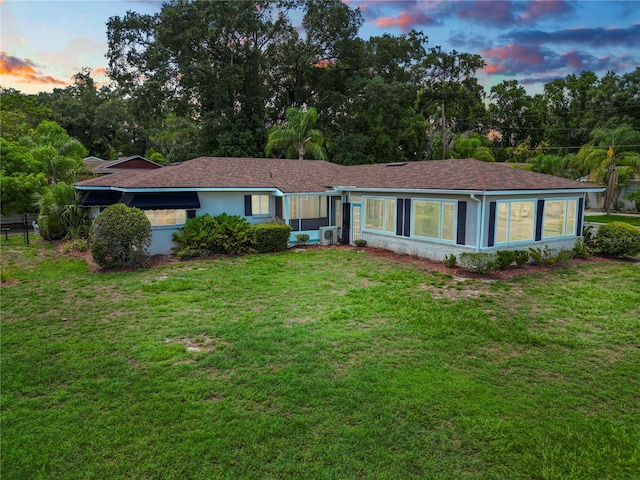 ranch-style house featuring a yard