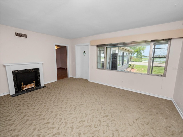 unfurnished living room with carpet floors and a high end fireplace