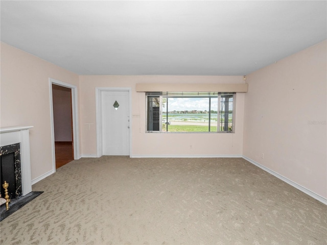 unfurnished living room featuring light colored carpet