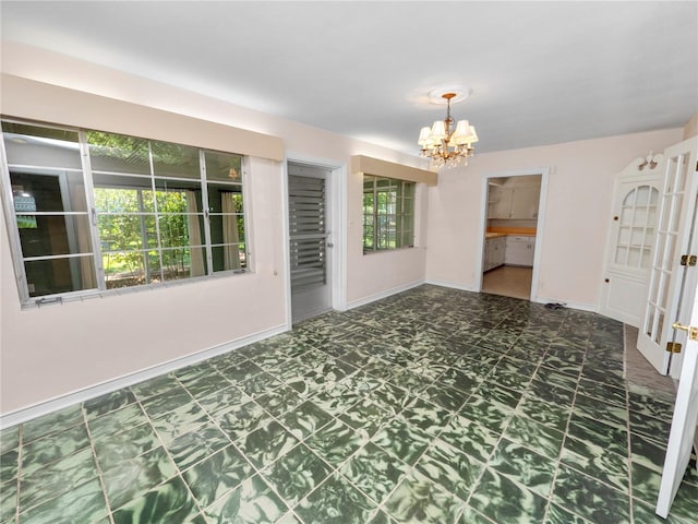 empty room featuring a chandelier